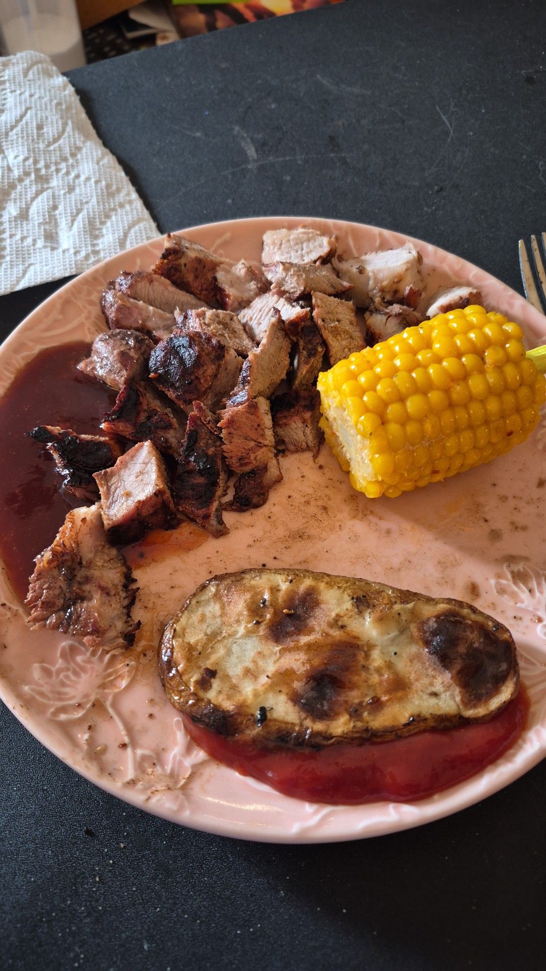 Pork steak with homemade BBQ sauce, sliced potatoes, and corn on the cob. 
Eatin' good over here!